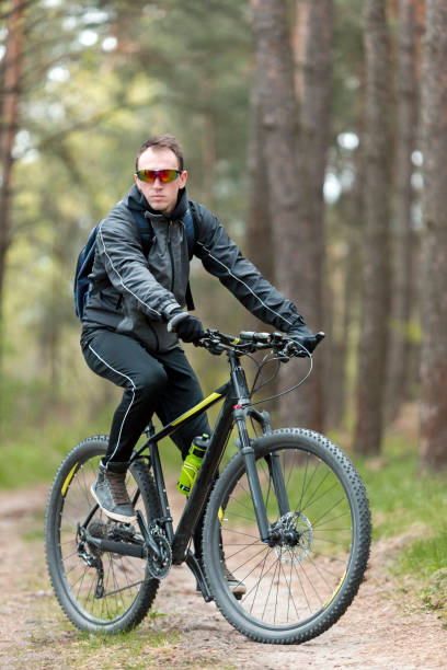 istock Man Rides a Bike in the Forest 672008488