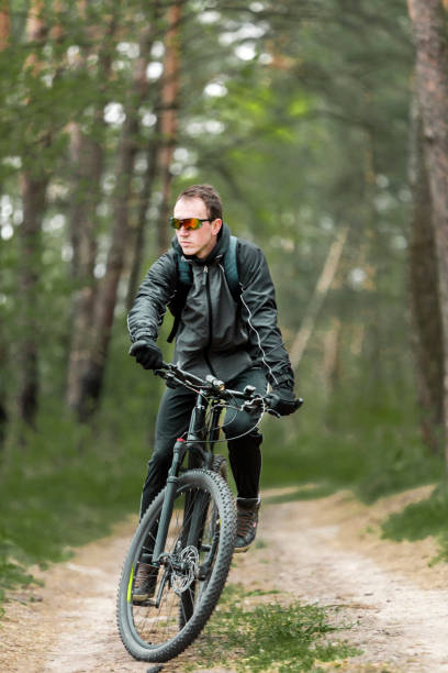 istock Man Rides a Bike in the Forest 672008528