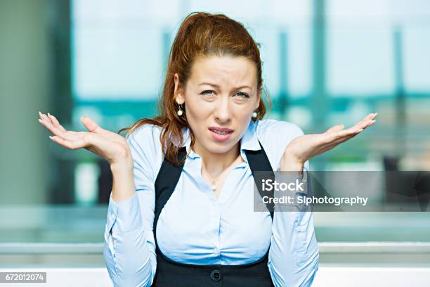 Clueless Unhappy Young Business Woman With Arms Out Asking Whats Problem Who Cares Stock Photo - Download Image Now