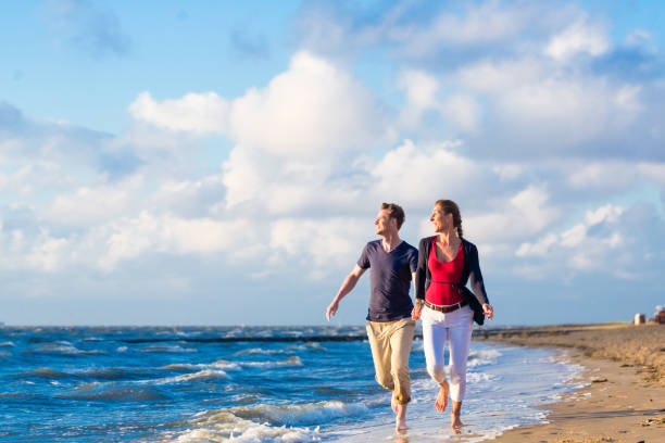 Couple enjoying romantic sunset at German north sea beach