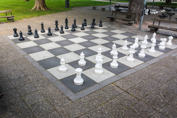istock Chess Pieces Board Outdoors Squares Park Large Strategy Asphalt 672019674