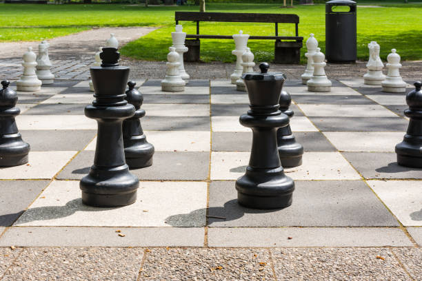 istock Chess Pieces Board Outdoors Squares Park Large Strategy Asphalt 672019836