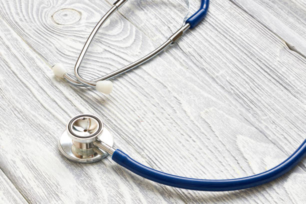istock Stethoscope on white wooden background 672029254