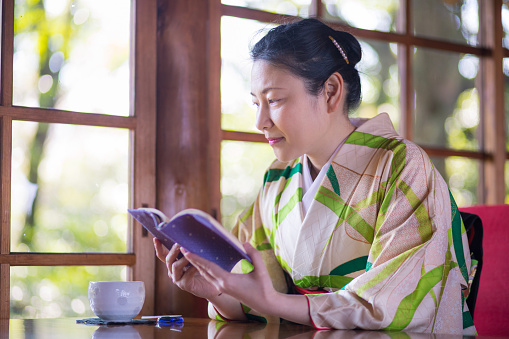 Woman in Kimono looking through window