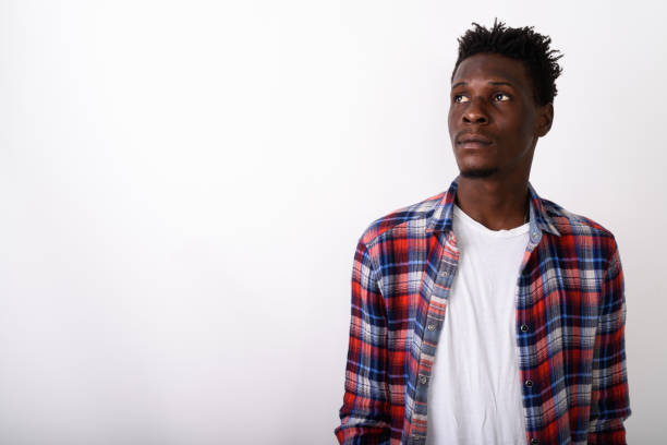 istock Studio shot of young black African man thinking while looking up against white background 672029690