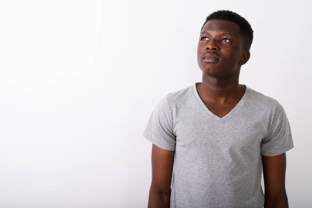 istock Studio shot of young black African man thinking while looking up against white background 672033210