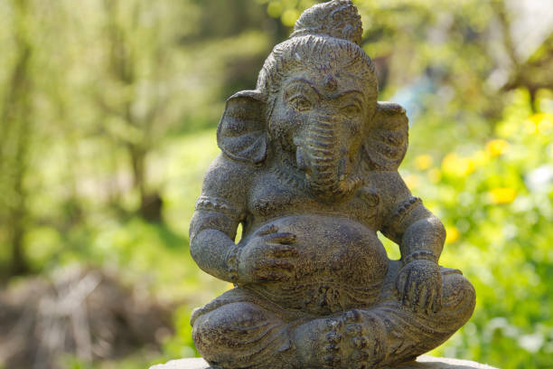istock ganesh stone statue in a garden 672033432