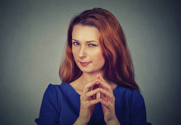 istock Closeup portrait of sneaky, sly, scheming young woman plotting something 672033572