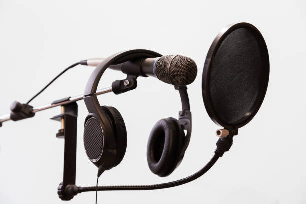 istock Cardioid condenser microphone, headphones and pop filter on a gray background. Home recording Studio 672033814