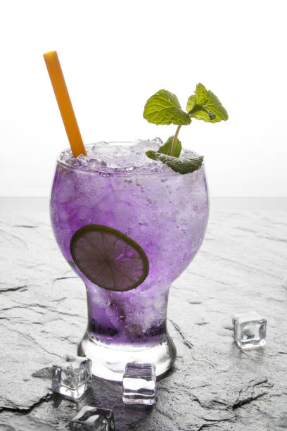 istock Purple soda lime drink with lime on stone. 672036138
