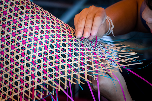 Close up Hands  weaving a woven mat   Thai's artwork.