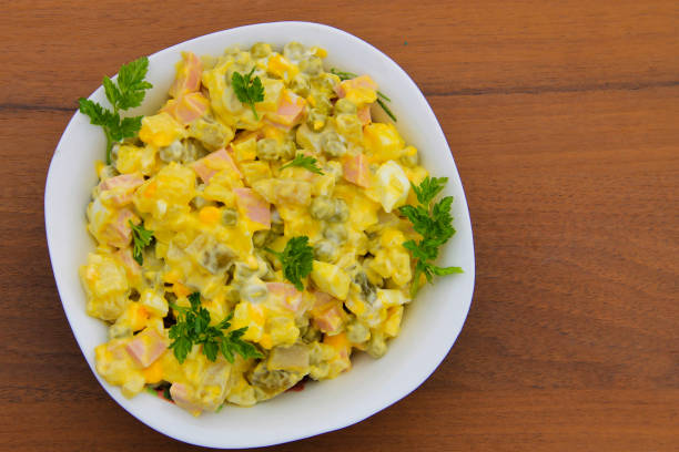 istock Russian traditional salad olivier on wooden table 672039348