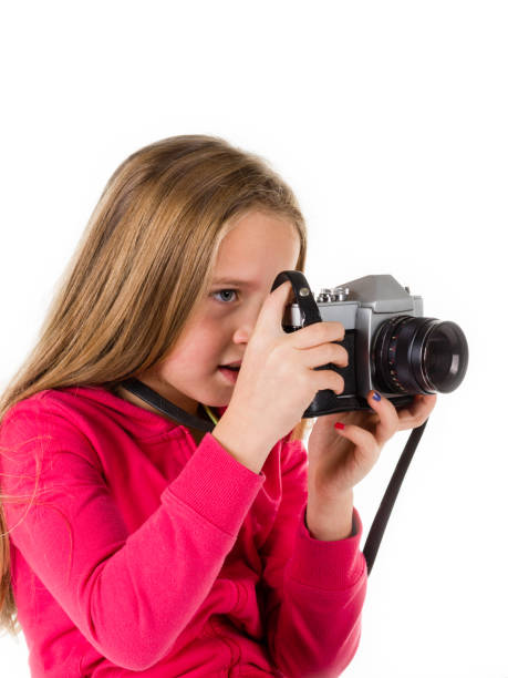 istock Girl with vintage camera isolated on white background 672040128