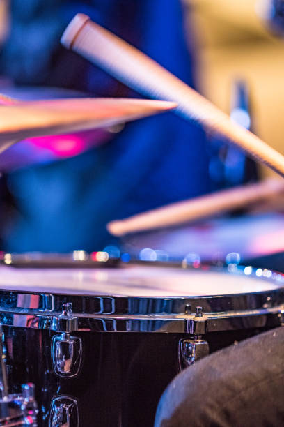 istock Drummer playing snare drum with hihat in the foreground 672040158