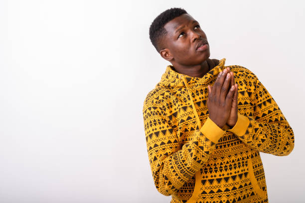 Portrait of young man in traditional African clothing, studio shot