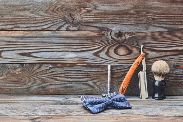 Photo of Vintage barber shop tools on wooden background