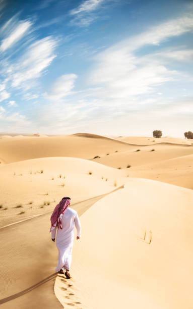 istock arabic man praying in the desert 672041448