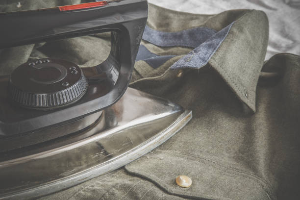 istock Old iron without steam system ironing clean crumpled shirt. 672042878
