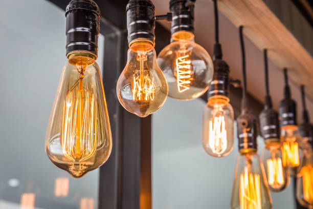 Decorative antique edison style filament old lighting decor bulb in modern building. Select focus Decorative antique edison style filament old lighting decor bulb in modern building. Select focus light bulb filament photos stock pictures, royalty-free photos & images