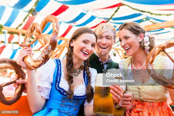 Friends With Giant Pretzels In Bavarian Beer Tent Stock Photo - Download Image Now - Beer Festival, Germany, Munich