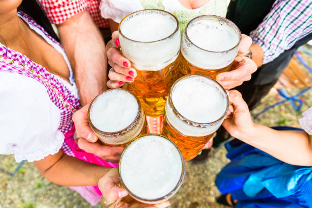 istock Clinking glasses with beer in Bavarian beer garden 672050008