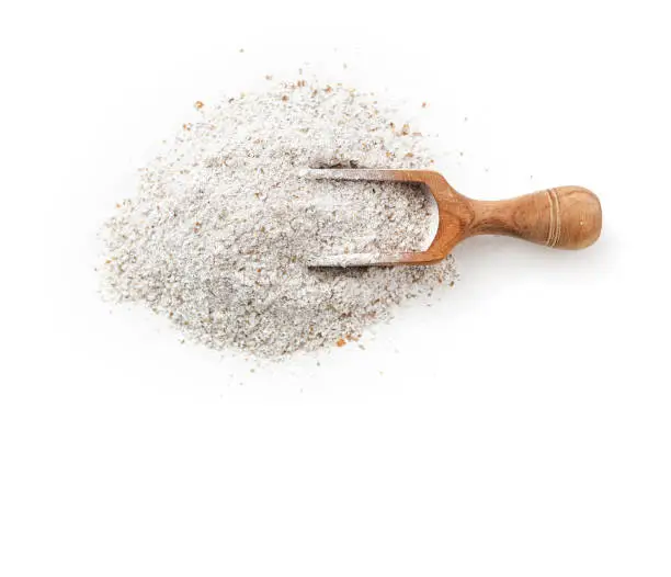 Rye flour in scoop on white background