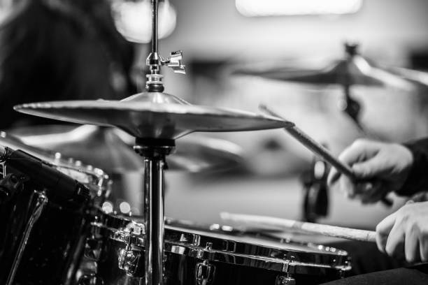 Drummer playing snare drum with hihat in the foreground