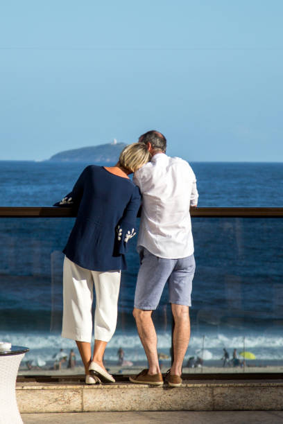 Mature couple from behind. Her head resting on his shoulder stock photo