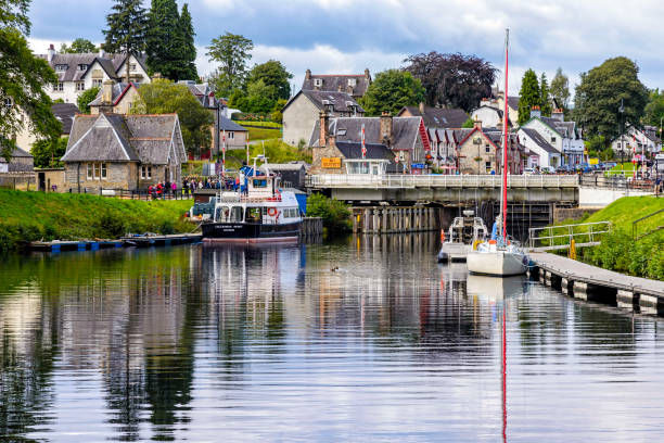 Caledonian Canal in Fort Augustus, United Kingdom Fort Augustus, United Kingdom - August 19, 2014: The caledionan canal at the Loch Ness lake. The Canal connects the Scottish east coast at Inverness with the west coast at Corpach near Fort William fort augustus stock pictures, royalty-free photos & images