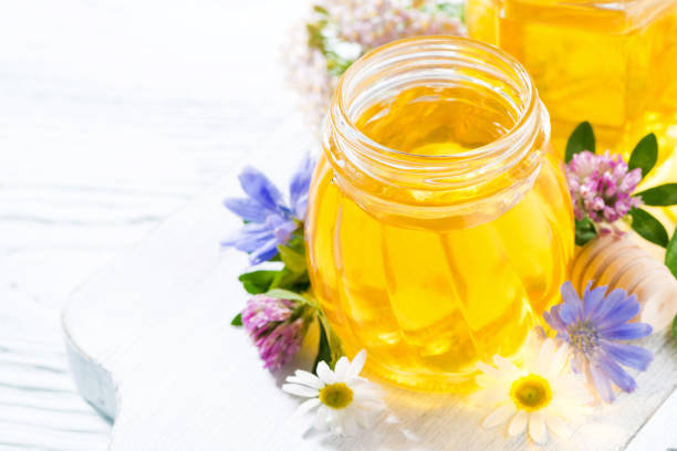 istock jars with fresh flower honey on white wooden board 672060986