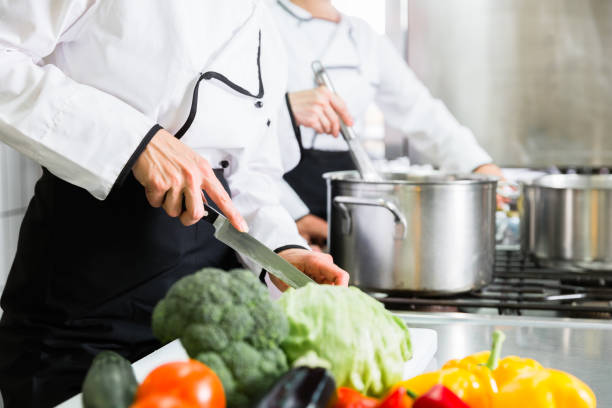 istock chefs preparing meals in commercial kitchen 672061270