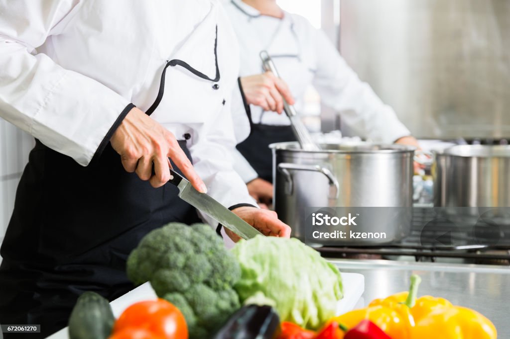 chefs preparing meals in commercial kitchen Team of chefs preparing food in canteen kitchen Commercial Kitchen Stock Photo
