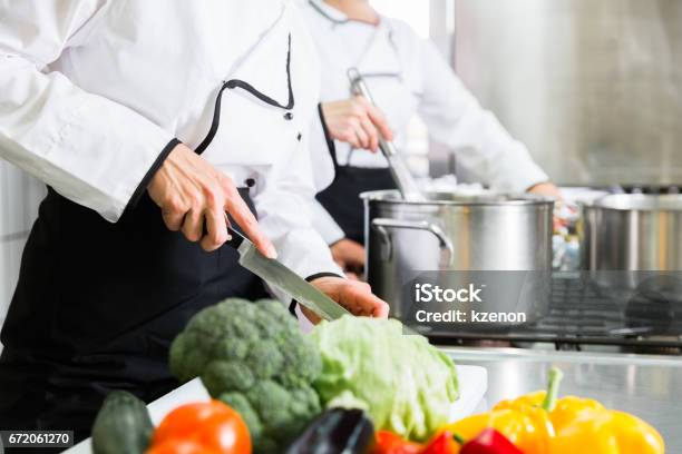 Chefs Preparing Meals In Commercial Kitchen Stock Photo - Download Image Now - Commercial Kitchen, Chef, Preparing Food