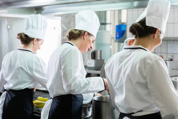 istock Female Chefs working in industrial kitchen 672061794