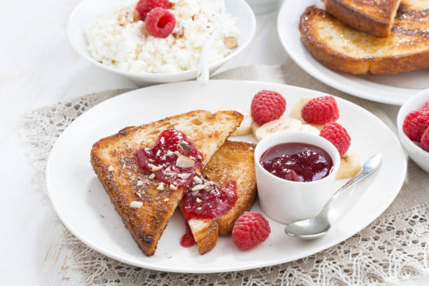 istock crispy toasts with fresh raspberries, banana and jam on plate 672067220