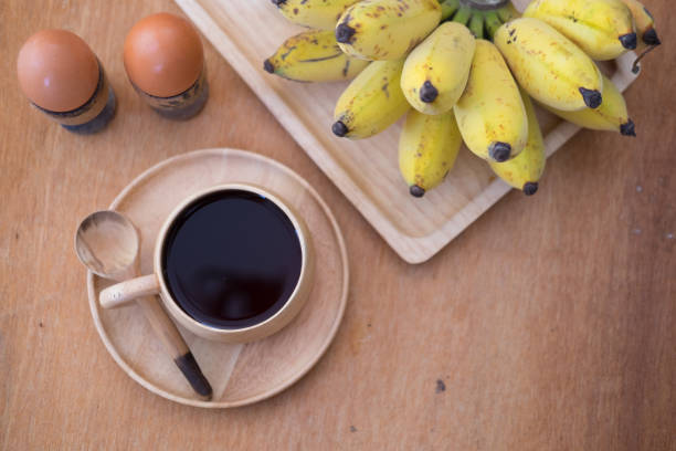 istock Healthy breakfast. Soft-boiled egg and banana with hot coffee 672070902
