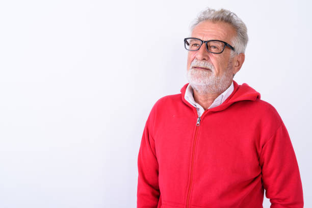 istock Close up of handsome senior bearded man thinking while looking up against white background 672071470