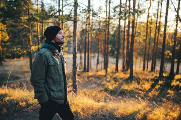 Photo of Young man walking in the beautiful forest outdoors