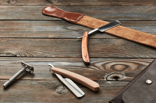 istock Vintage barber shop razor tools on wooden background 672089536