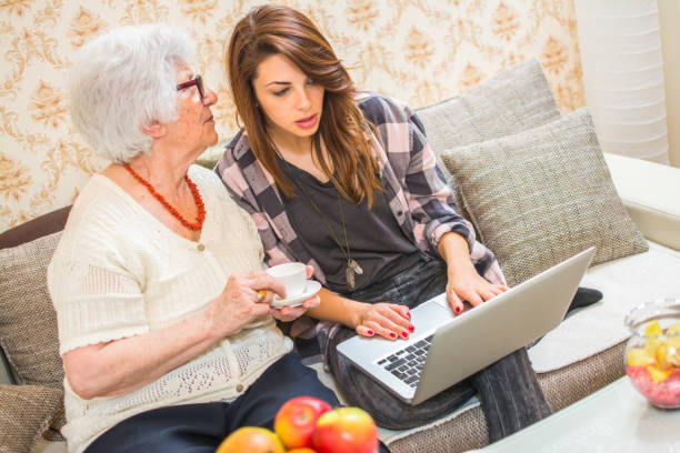istock Grandmother whispering something to her granddaughter's ear. 672093540