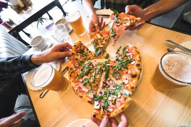 istock eating the pizza all together at the cafe 672096934