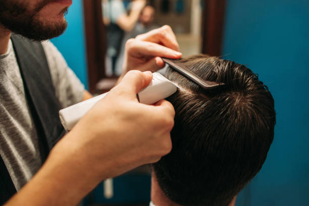 istock Hair cutting process at barbershop closeup 672097214