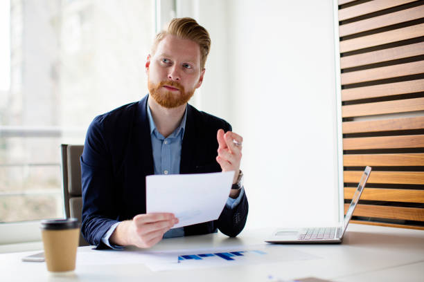 istock Young businessman holding contract 672099830