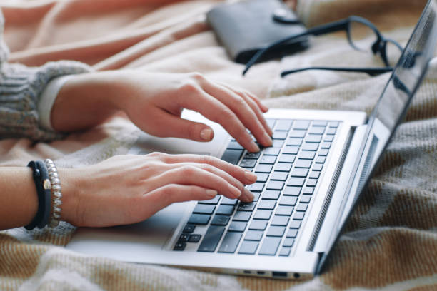 Female hands type on laptop. Job searching online. stock photo