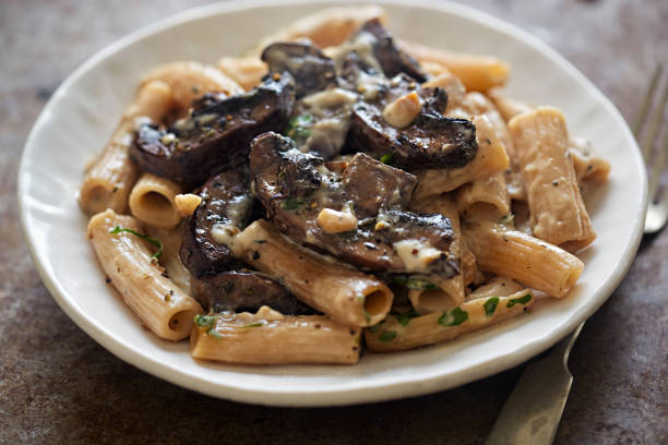istock Pasta rigatoni with mushroom sauce and nuts 672106552