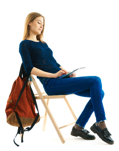 girl sitting on a chair with pad stock photo