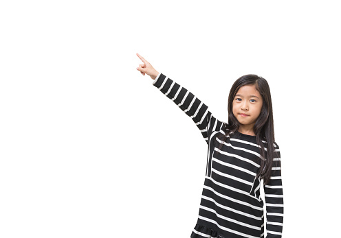 Cute asian girl kid point her finger up on white copy space background for text decoration and design (isolated shape with clipping path included)