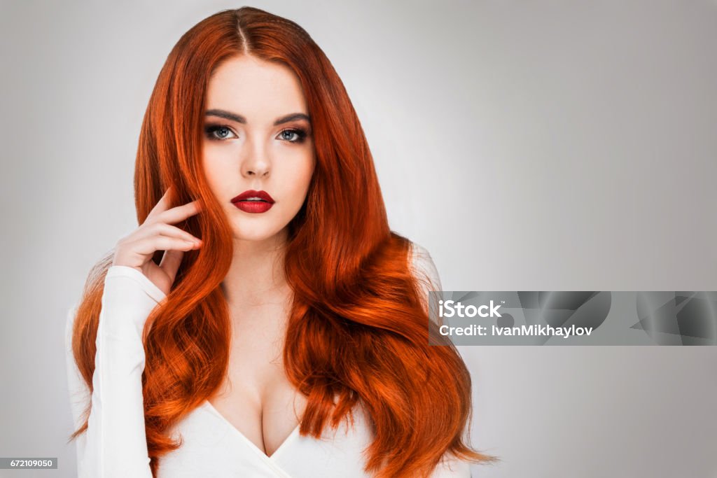 Gorgeous redhead girl Gorgeous redhead girl with wavy hair beauty studio portrait Sex Symbol Stock Photo