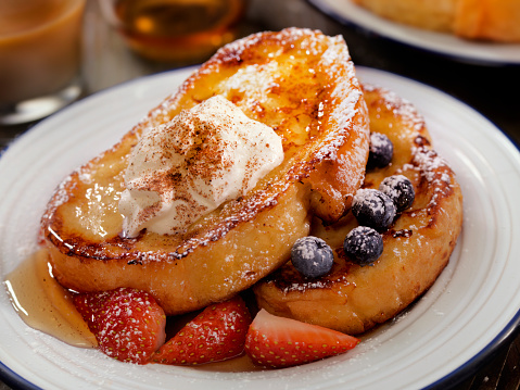 French Toast with Maple Syrup, Berries Whip Cream and Cinnamon