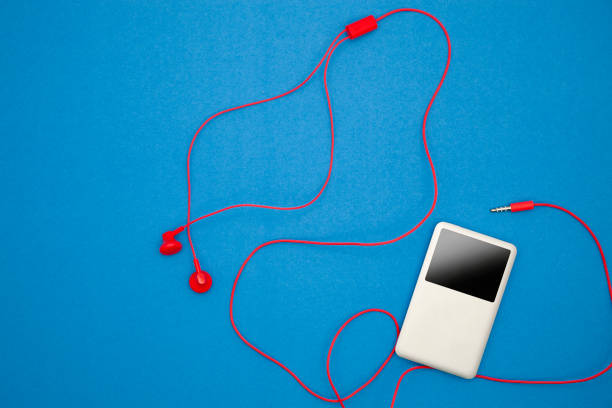 istock Music player with red earphone on blue paper background. 672116394